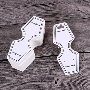 Detailed view of premium white paper jewelry display cards for necklaces and earrings