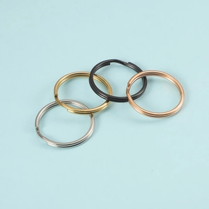 Detail of four stainless steel split rings in silver, gold, black, and rose gold finish