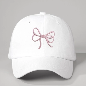 White cotton baseball cap with pink embroidered bows and adjustable strap for outdoor sun protection