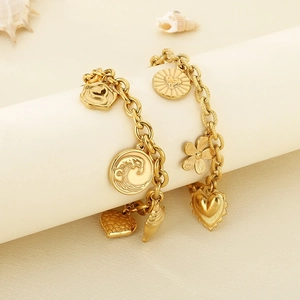 Golden stainless steel beach bracelets with shell, wave, and heart charms on pedestals