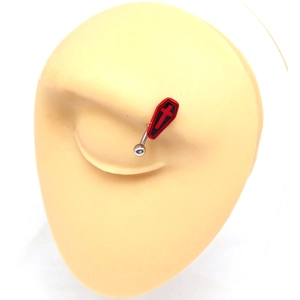 Macro shot of an eyebrow piercing with red coffin pendant on a beige mannequin