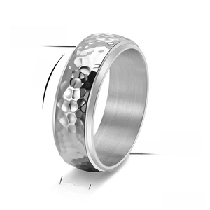 Detail view of 8mm spinning titanium steel ring with honeycomb hammered texture finish