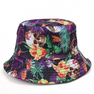 Reversible bucket hat with tropical leaf and white skull print on black cotton fabric