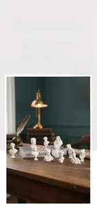 Detailed macro view of classic resin busts on vintage books with warm lighting