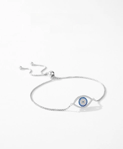 Macro shot of silver S925 Evil Eye bracelet with blue cubic zirconia and adjustable toggle clasp