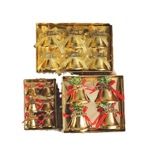 Three sets of gold Christmas bell ornaments with Merry Christmas engraving in gift boxes