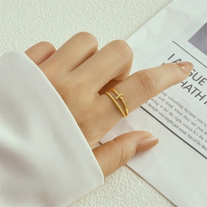 Double-layered gold teardrop ring on hand featuring thin beaded and smooth bands