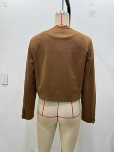 Back view of a cropped brown faux suede jacket with long sleeves on a mannequin