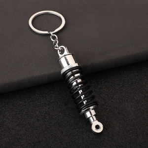 Close-up of automotive shock absorber keychain with realistic silver and black metal coil