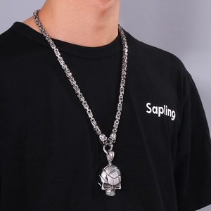 Detailed view of punk skull pendant with crystal eyes on heavy metal king chain