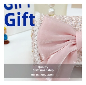 Detail of pink tweed bag with large bow, white lace trim and pearl handle charm