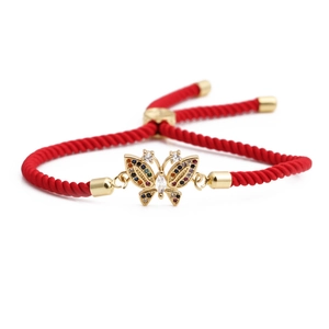 Adjustable red rope bracelet featuring a golden butterfly pendant with colorful zircons