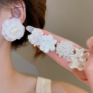 Detail of 10-piece pearl flower stud earring set showing lace and petal textures