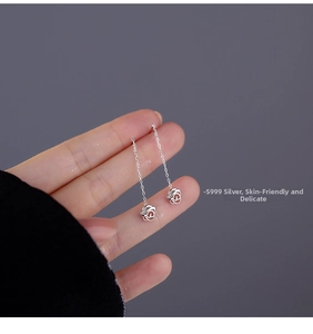 Dettaglio di orecchini a nappa con rosa traforata in argento sterling S999 lucido