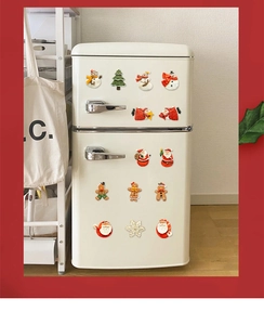 Detailed view of colorful 3D resin Christmas magnets on a vintage cream refrigerator