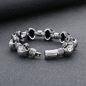Detailed shot of punk skull head links and polished clasp on stainless steel bracelet