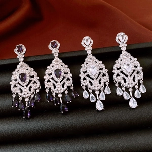 Detail view of luxury flower tassel earrings with pear-cut zircon in purple and silver