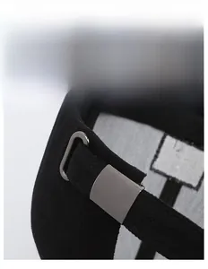 Detail view of the black baseball cap showing the adjustable metal buckle and cotton fabric
