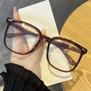 Detail of translucent dark brown square glasses frame showing model CY5582 on temple