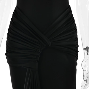 Detailed view of elegant waist pleats and draped fabric on a black bodycon maxi dress