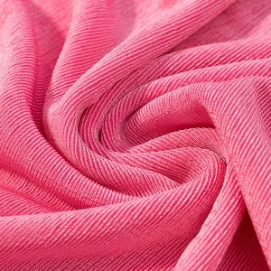 Detailed macro view of bright pink ribbed knit fabric with soft elastic texture
