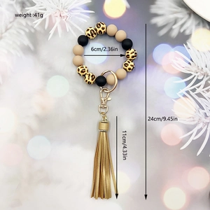 Detail view of silicone bead bracelet keychain with leopard print and golden tassel