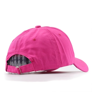 Detail of rose red washed baseball cap showing metal adjustable buckle and twill texture