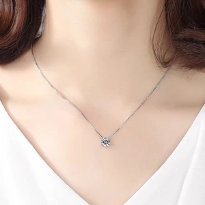 Elegant silver minimalist necklace with a sparkling round zircon pendant on model neck