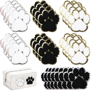 Detailed texture of plush cat paw embroidery patches and white canvas zipper pouch