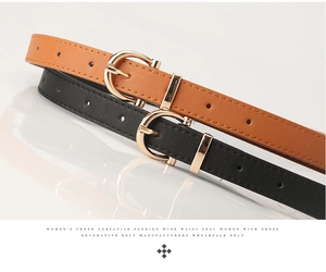 Detailed close-up of classic black and brown PU leather belts with gold D-ring buckles