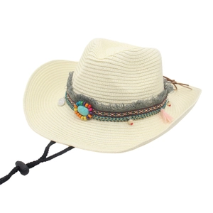 Detail of cream straw cowboy hat with ethnic beads, turquoise stone and tassels