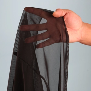Close-up of black sheer mesh fabric texture on sexy split beach maxi dress