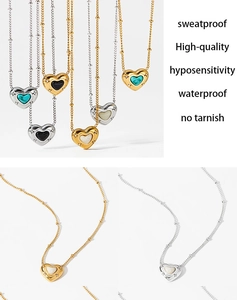 Macro detail of heart-shaped natural stone pendants with gold beaded edges on a chain