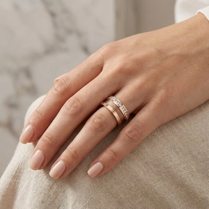 Rose gold multi-layer ring featuring Roman numerals, steel cable, and white zircon accents
