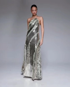 Close-up of silver sequin dress showing detailed glitter texture and halter neck design