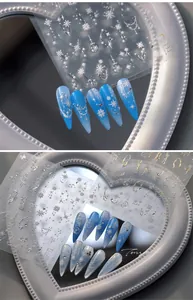 Detail of 5D silver snowflake nail stickers with embossed starburst and vine patterns