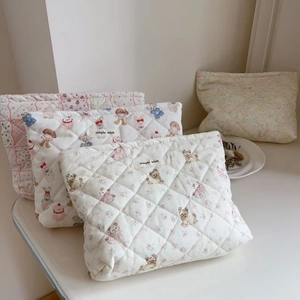 Quilted cotton makeup bags with cute cartoon animal prints and floral patterns in detail view