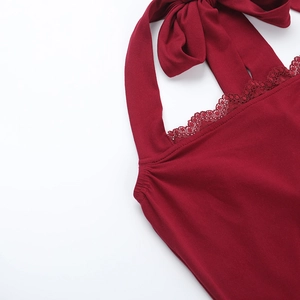 Detail des roten Halter-Tops mit aufwendigem Spitzenbesatz und einer feinen Schleifendekoration