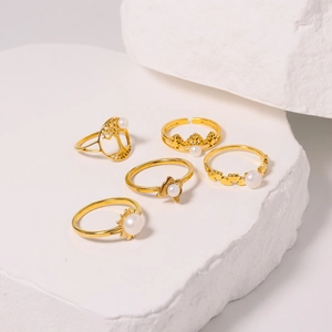 Cinq bagues dorées en titane avec perles motifs arbre de vie couronne et cœur