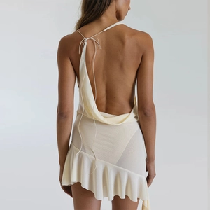 Detail showing backless design with thin lace-up straps and ruffled asymmetric hemline