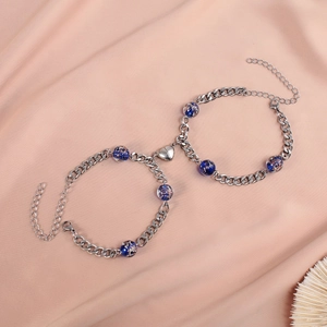 Close-up of heart magnet clasp and luminous beads on stainless steel Cuban chain bracelets