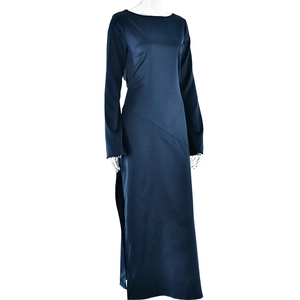 Detailed view of dark blue long sleeve satin dress with elegant side slit on a mannequin
