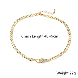 Detail of 18K gold plated Cuban chain necklace with zircon studded snake head clasp