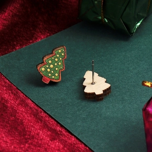 Detail of wooden Christmas tree stud earrings with green texture and silver pins
