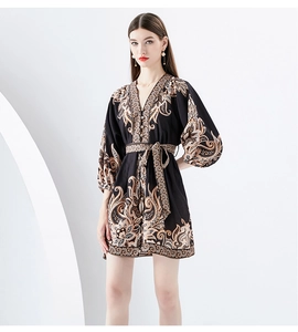 Detailed view of V-neck printed mini dress with lantern sleeves and paisley pattern