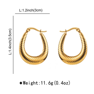 Detailed view of chunky golden hoop earrings with twisted texture and size measurements