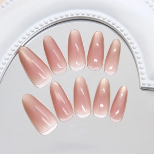 Cat eye gradient nude pink press-on nails with white French tips in almond shape