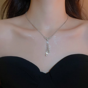 Silver Y-shaped tassel necklace with sparkling rhinestones worn on a female model neck