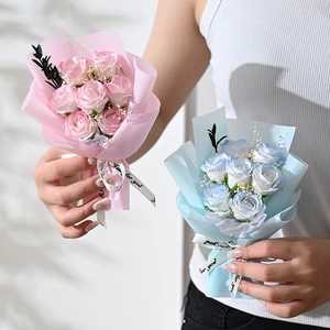 Detail of handmade soap rose bouquets with for you ribbons held by a model