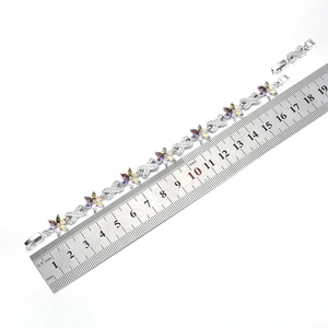 Detail view of 19cm floral silver bracelet with colorful zircons and measuring scale